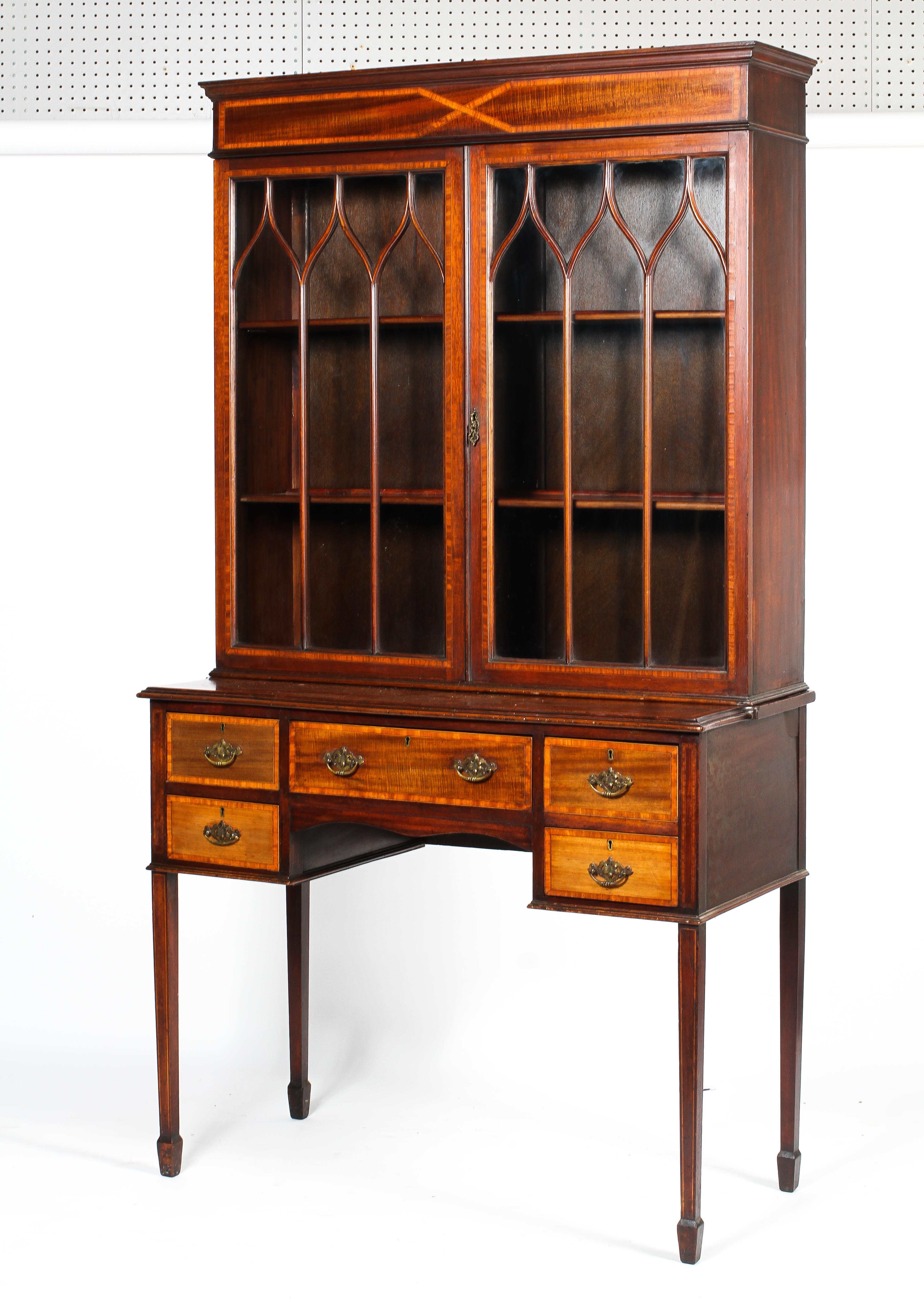 An Edwardian inlaid mahogany astragal glazed bookcase-writing desk.