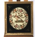 A Victorian needlework in verre eglomise giltwood frame.