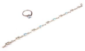 A silver single synthetic blue stone dress ring.