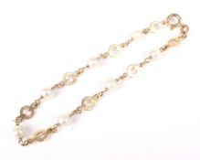 An 18ct gold link and pearl bracelet.