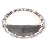 An Egyptian silver tray. Of circular scalloped form with reeded flowerhead and ribbon rim,