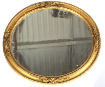 A Victorian gilt framed oval mirror.