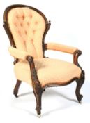 A Victorian mahogany framed button back elbow chair.