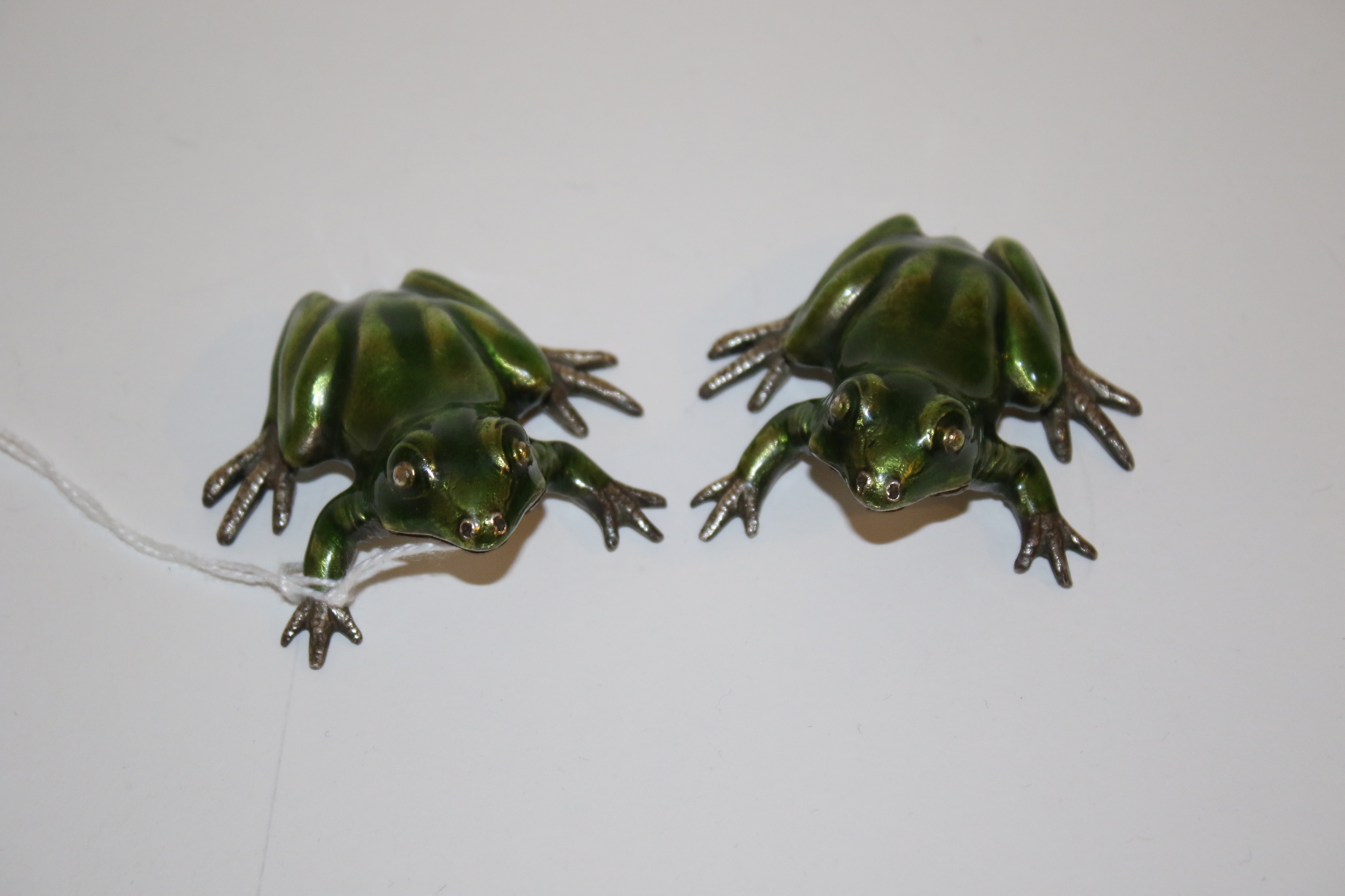A pair of Italian silver and enamel frogs.