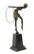 An Art Deco bronze sculpture of a dancing woman with hoop after Erte.