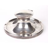 A George V silver capstan inkwell and liner.