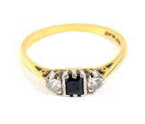 An 18ct gold and platinum set three stone sapphire and diamond ring.