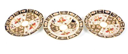 A Royal Crown Derby imari pattern muffin dish and two plates.
