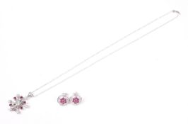 A ruby and diamond 'snowflake' cluster pendant and chain, and a pair of cluster stud earrings.