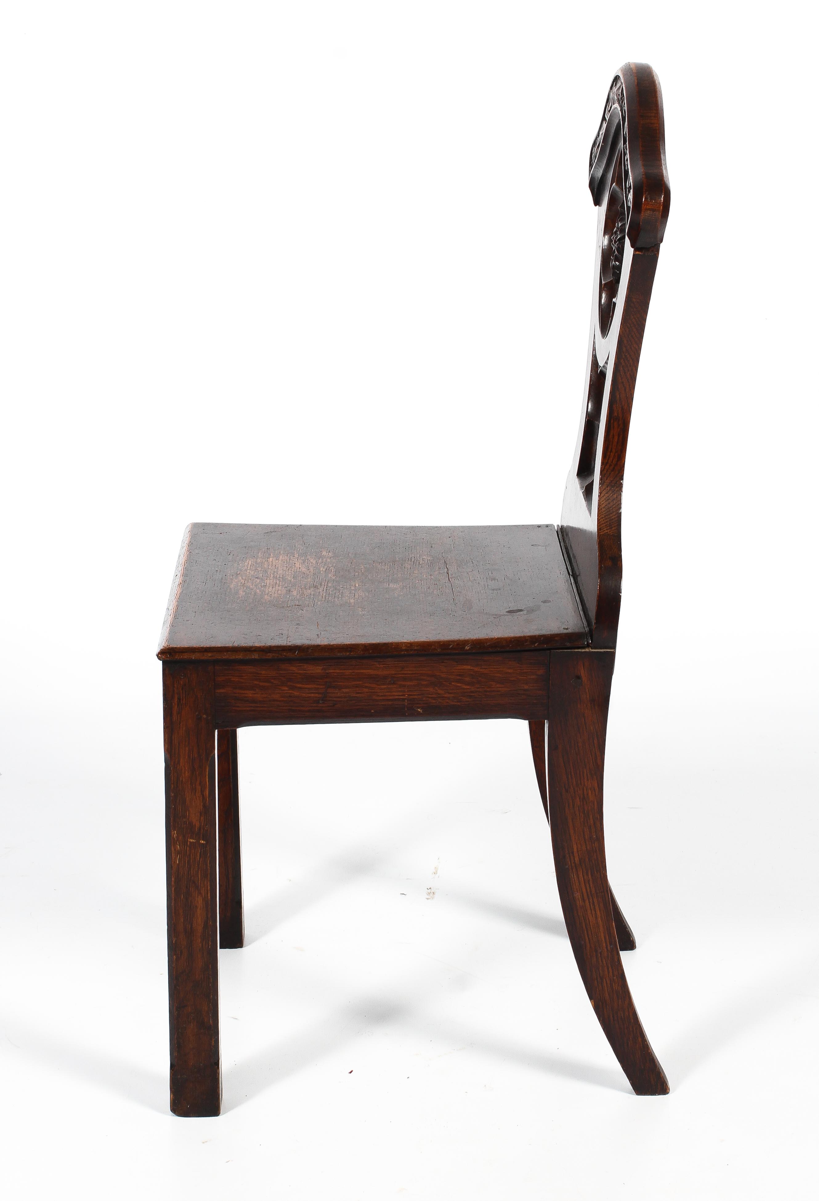 An early 20th century oak hall chair. - Image 2 of 2