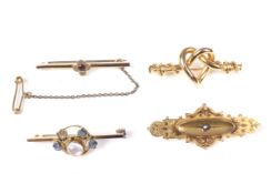 Four Victorian and later gold brooches.