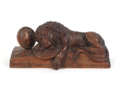 A Swiss carved wooden model of the Lion of Lucerne.