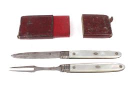 A Georgian silver and mother of pearl mounted folding travelling fruit knife and fork set in red