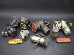 Five vintage acetylene bicycle lamps.