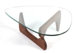A retro pebble shaped glass topped table. With curved wooden supports, 123cm wide x approx.