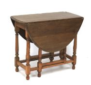 A 20th century oak gateleg and drop leaf table.