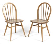 A pair of Windsor elm and beech spindle back dining chairs.