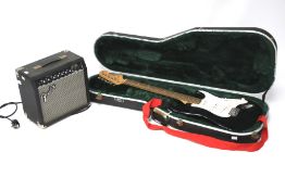 A Frontman 15R amplifier and a Squier Strat by Fender electric guitar. The amp serial no.