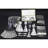 A twelve setting set of cutlery and a boxed set of berry spoons.