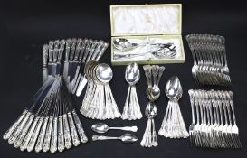 A twelve setting set of cutlery and a boxed set of berry spoons.