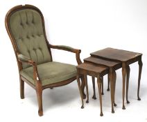 A 20th century elbow chair and a nest of three veneered tables.