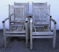 Four teak slatted garden armchairs. Labelled Cotswold Teak, 100cm high max.