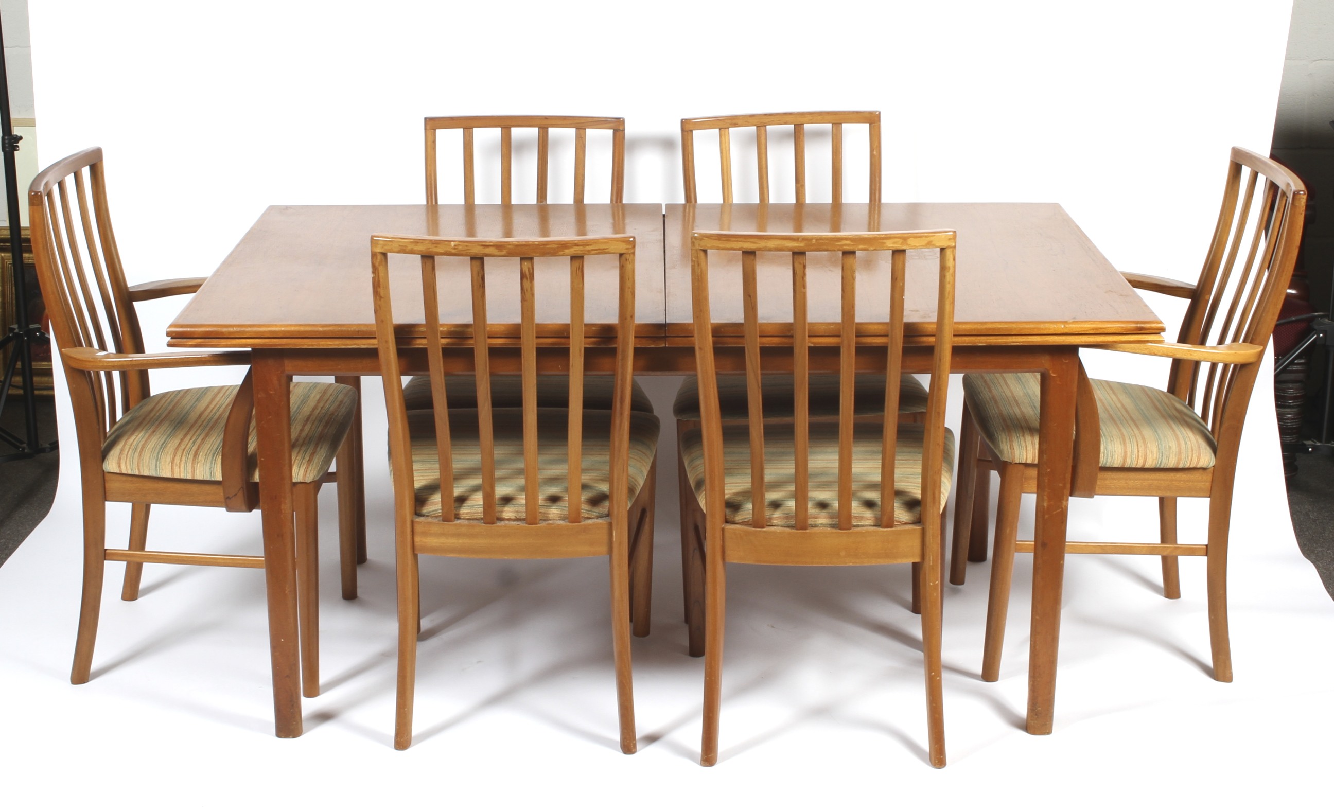 A teak extending dining table and chairs.