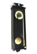 A wooden cased wall clock.