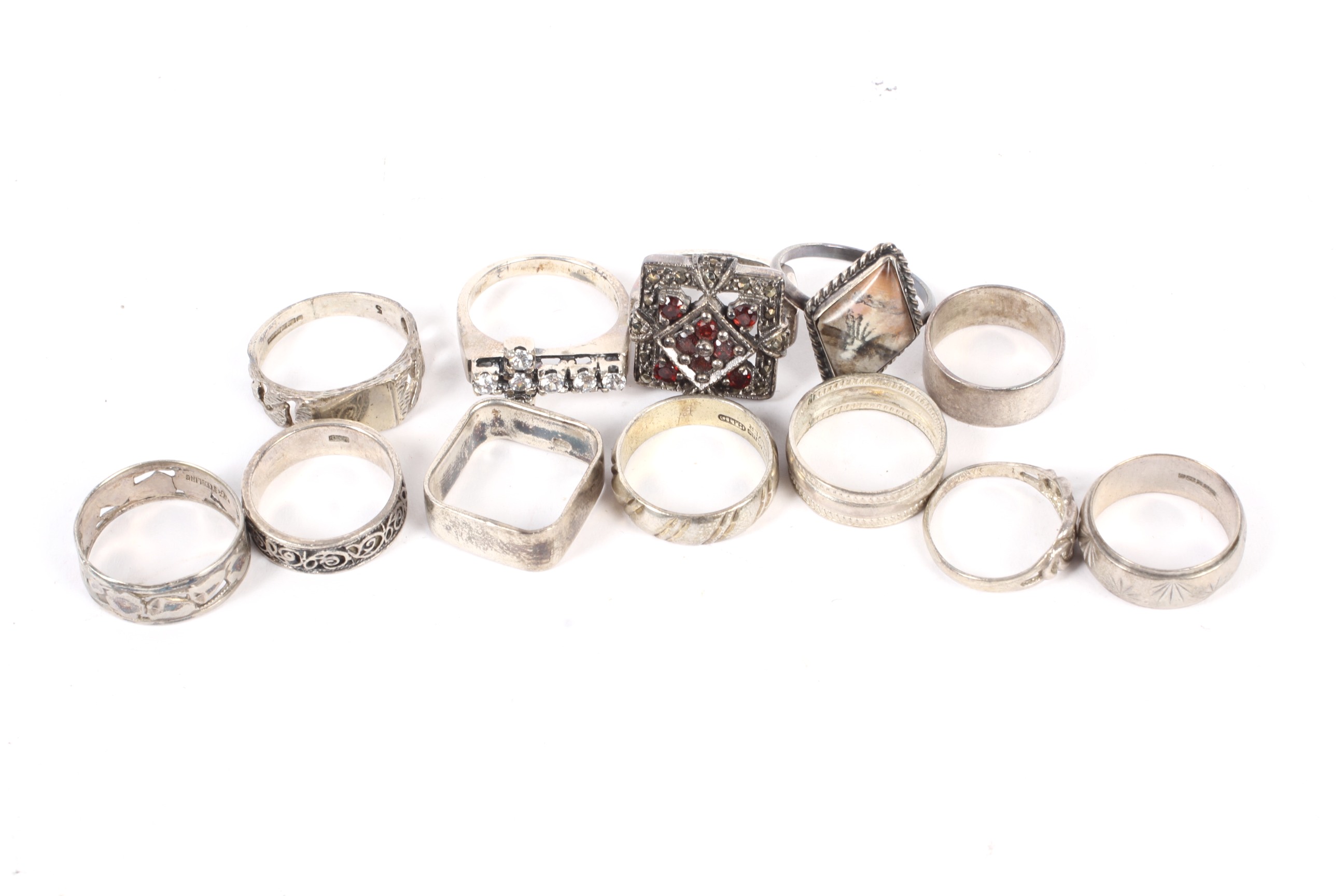 A collection of silver and white metal rings.