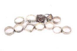 A collection of silver and white metal rings.