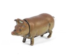A brass vesta case and match strike in the form of a pig.