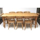 A large 20th century pine kitchen table and eight chairs.