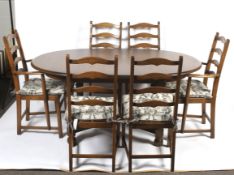 An Ercol oak extending dining table and six chairs.