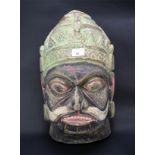 A large carved wooden Indian deity mask.