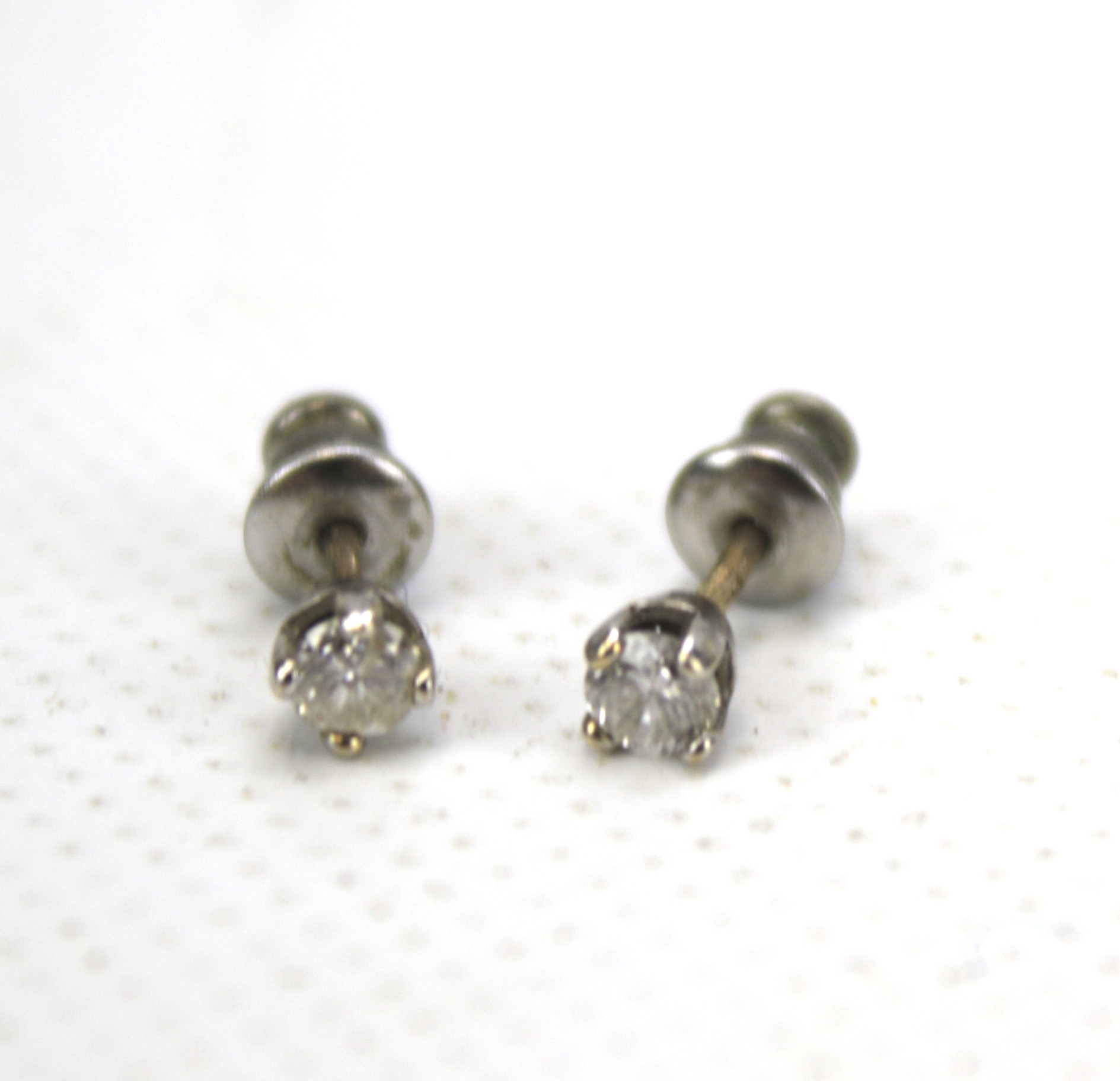 A pair of 9ct gold and diamond stud earrings. Approximately 0. - Image 2 of 3