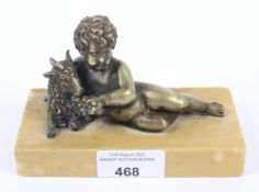 An early 20th century metal figure depicting a Bacchic putti with goat.