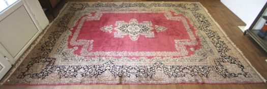 A Persian style machine made room size carpet.