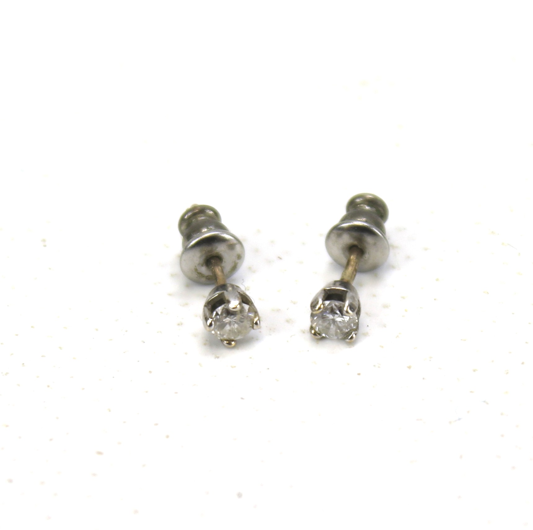 A pair of 9ct gold and diamond stud earrings. Approximately 0.