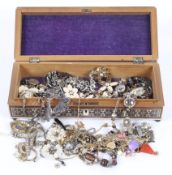 Assorted costume jewellery in a wooden box.