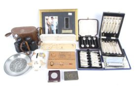 A box of mixed collectables, including flatware, binoculars, harmonica and other items.