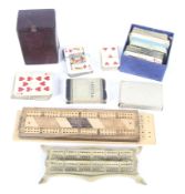 A collection of vintage playing cards, wooden cribbage boards and other items.