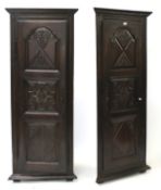 A pair of 20th century oak panelled floor standing corner cupboards.