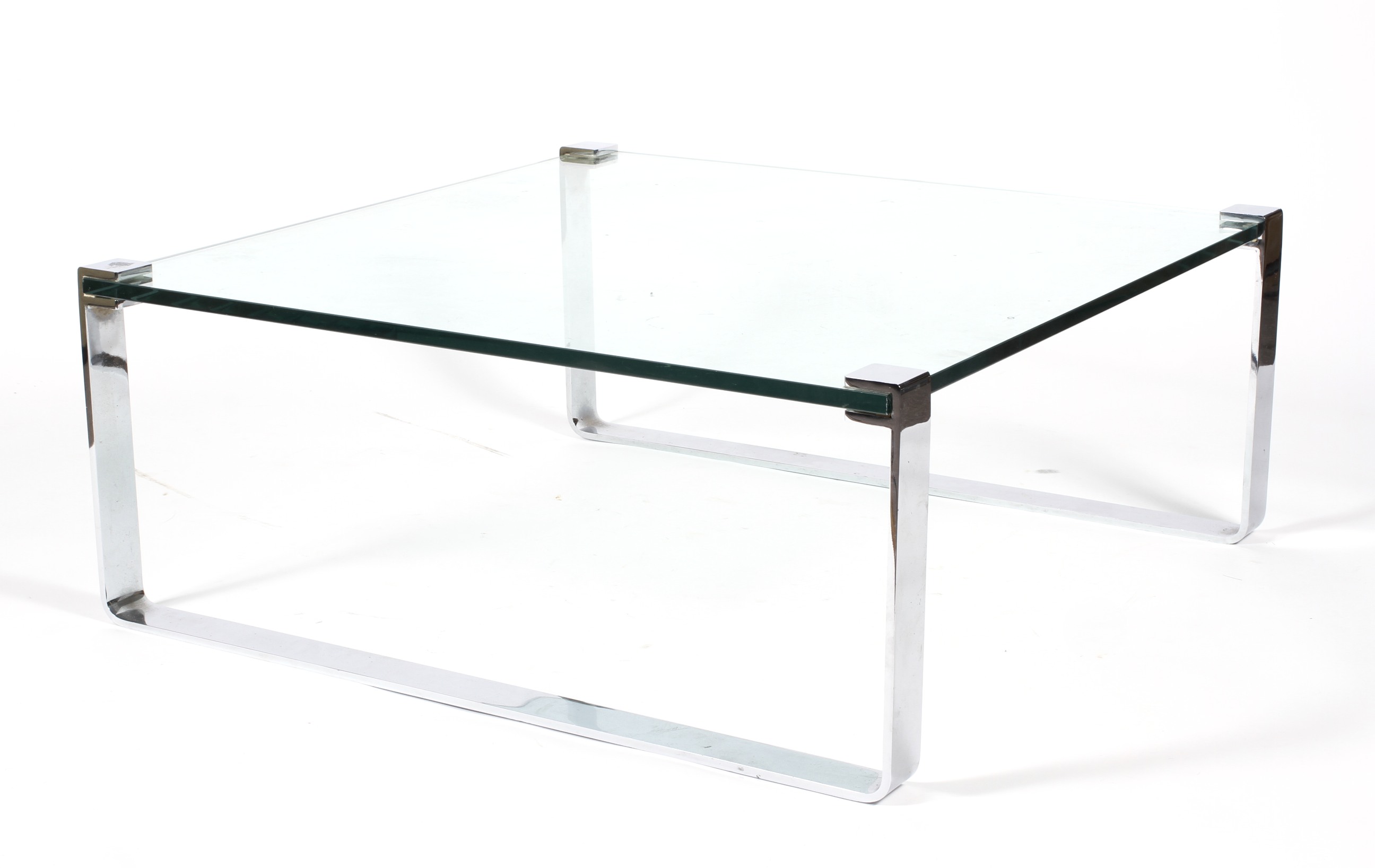 A large circa 1970s chrome and heavy glass coffee table.