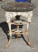 A Victorian cast iron white painted table with later wooden top.