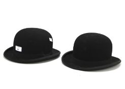 Two vintage black felt bowler hats.