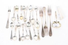 Assorted white metal and silver-plated flatware.
