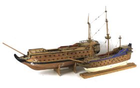 Two handmade wooden models of galleon ships.
