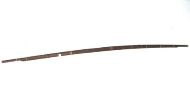A 20th century carved wooden string bound bow.