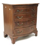 A 20th century mahogany serpentine chest of drawers.