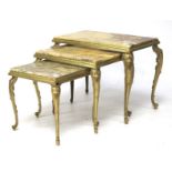 A nest of three gilt metal mounted stone topped tables.